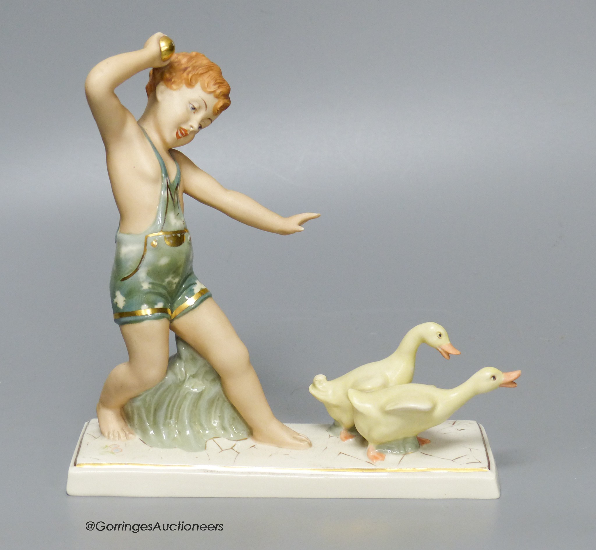 A Royal Dux group of a boy with ducks, 18cm tall